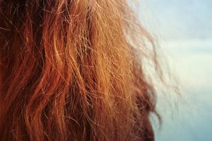 What causes frizzy hair, and how can I stop it?